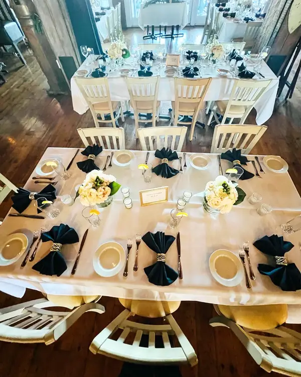 Long banquet table with navy napkins