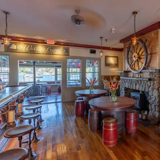 Tavern with stone fireplace and ship's wheel