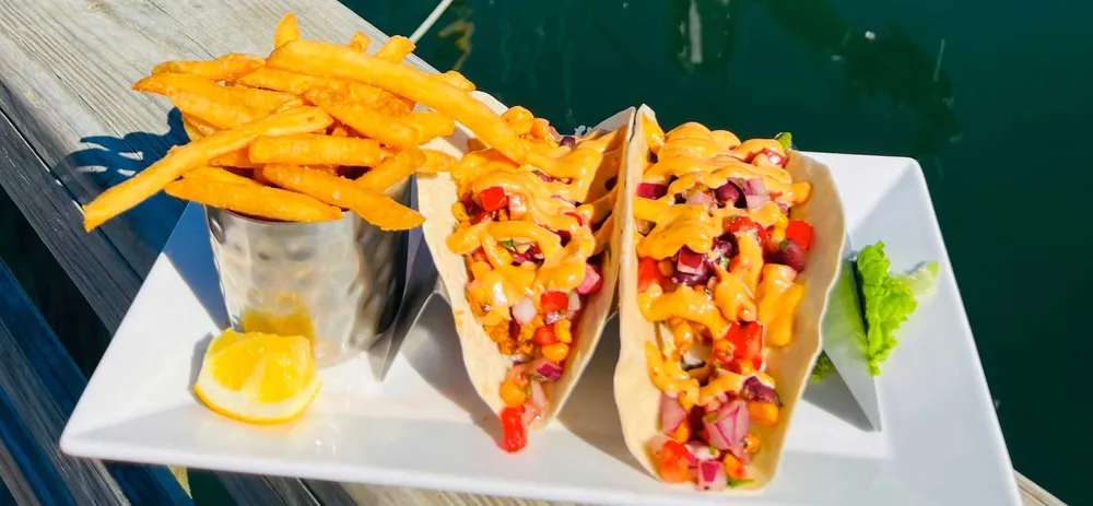 Dayboat tacos with fries on a dock table